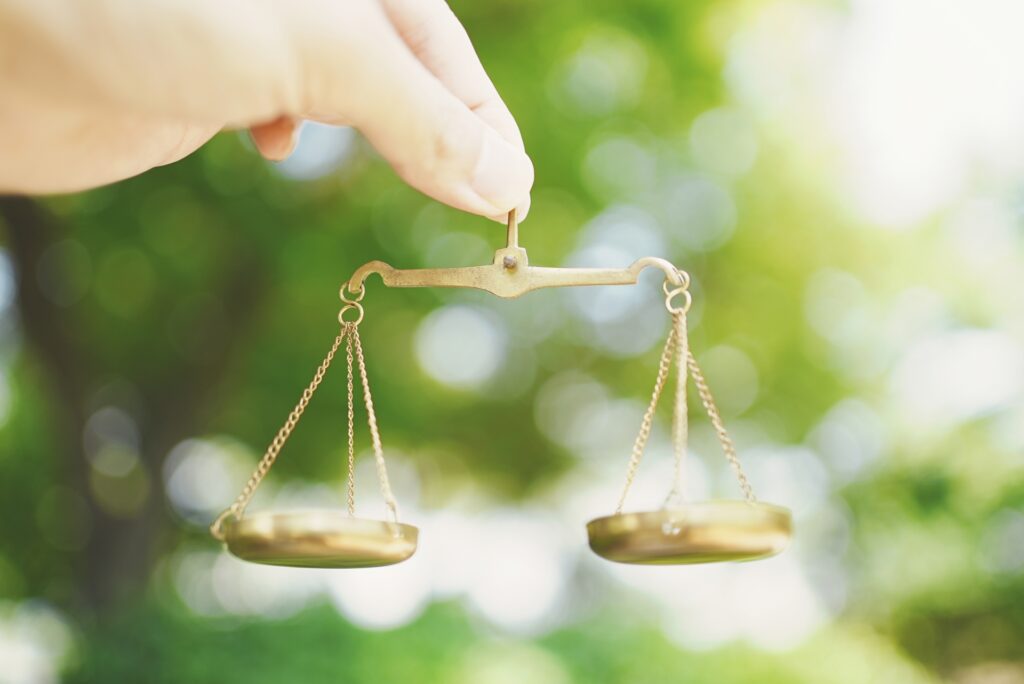 天秤を持つ手│2社を比較するイメージ